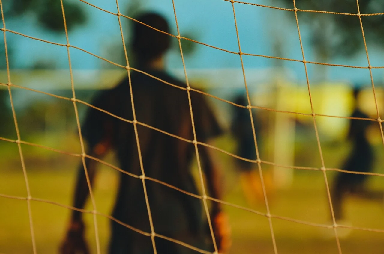 Goalkeeper through the goal net