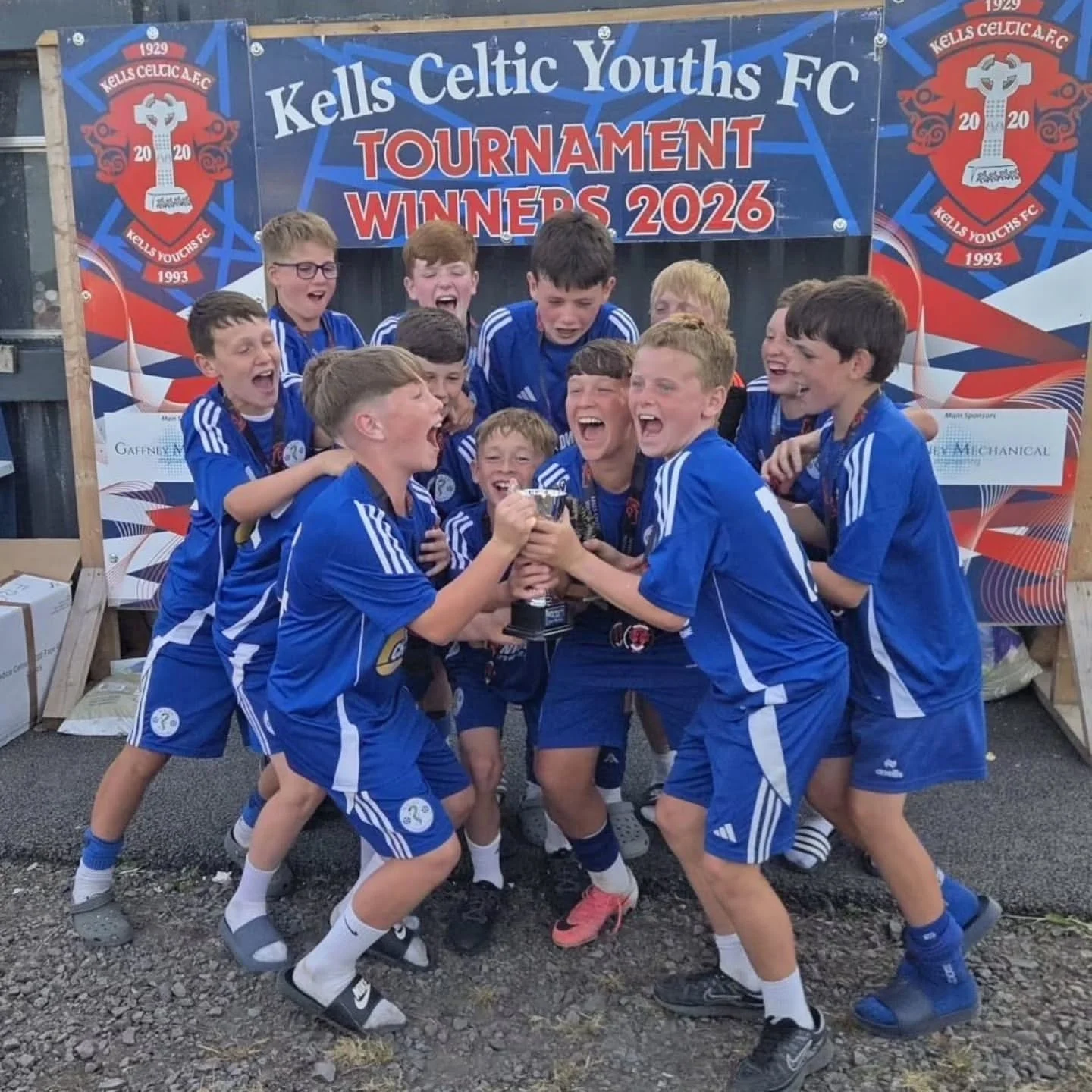 Naas AFC squad celebrating in club colours