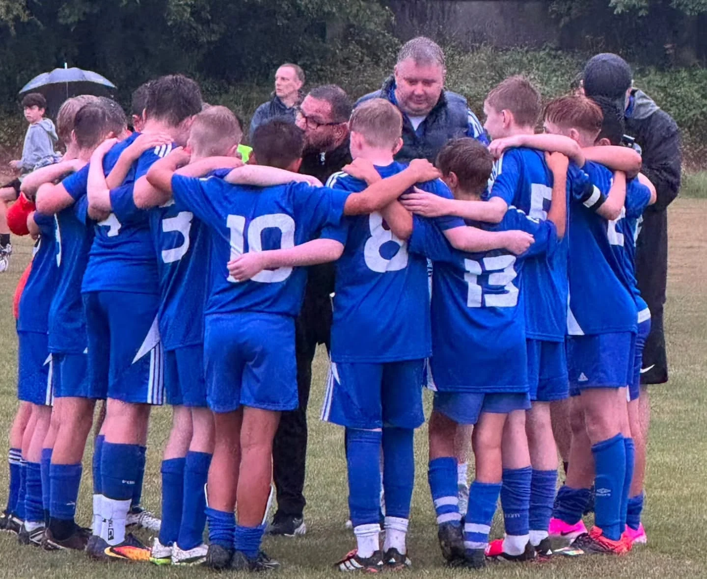 Naas AFC squad in team huddle match action