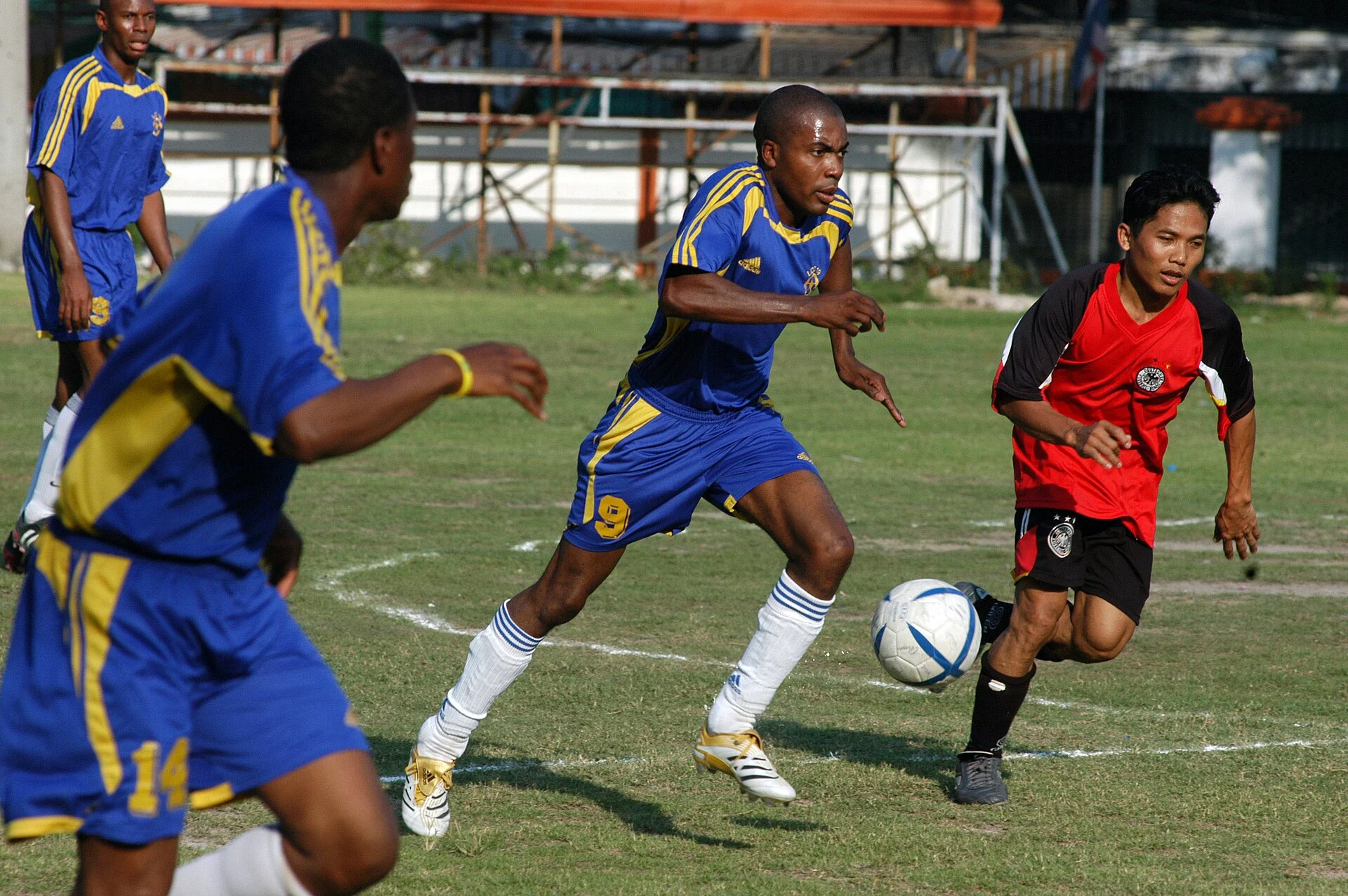 Player runs the ball downfield during a soccer match